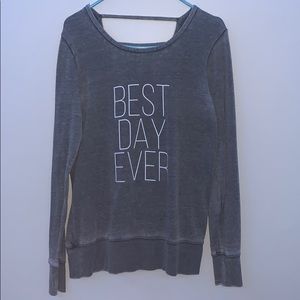 A gray long sleeve sweater with a ripped back